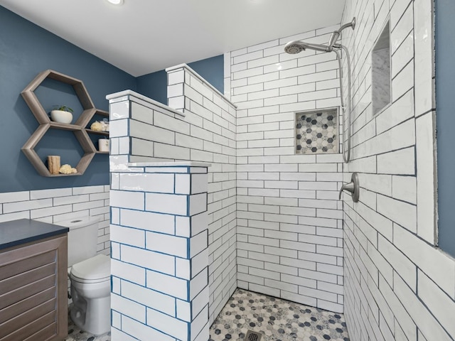 full bath featuring tiled shower, tile walls, and toilet