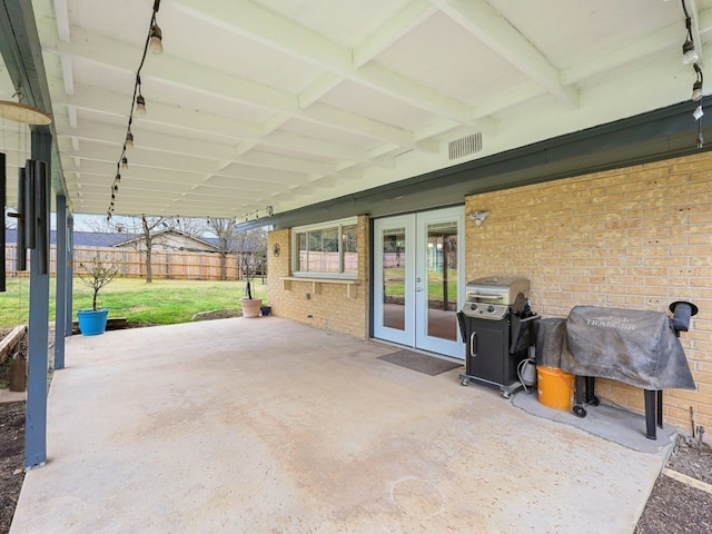 view of patio / terrace featuring french doors, a grill, and fence