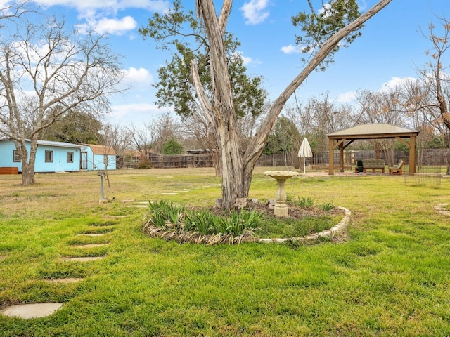 view of yard featuring fence and a gazebo