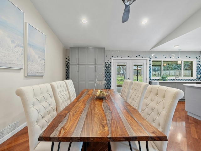 dining room featuring french doors, visible vents, baseboards, and wood finished floors