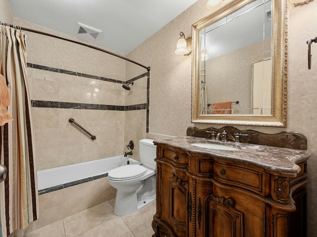 full bathroom featuring visible vents, toilet, tile patterned floors, tiled shower / bath, and vanity