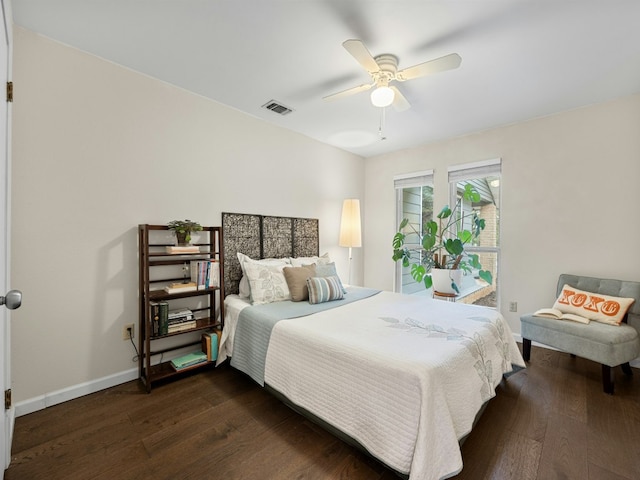 bedroom with a ceiling fan, dark wood finished floors, visible vents, and baseboards