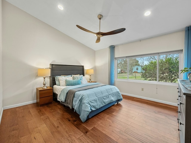 bedroom featuring lofted ceiling, hardwood / wood-style flooring, baseboards, and recessed lighting