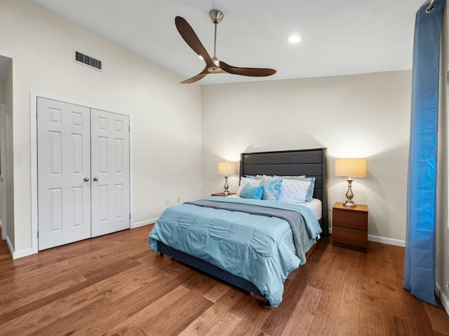 bedroom featuring wood finished floors, visible vents, and baseboards