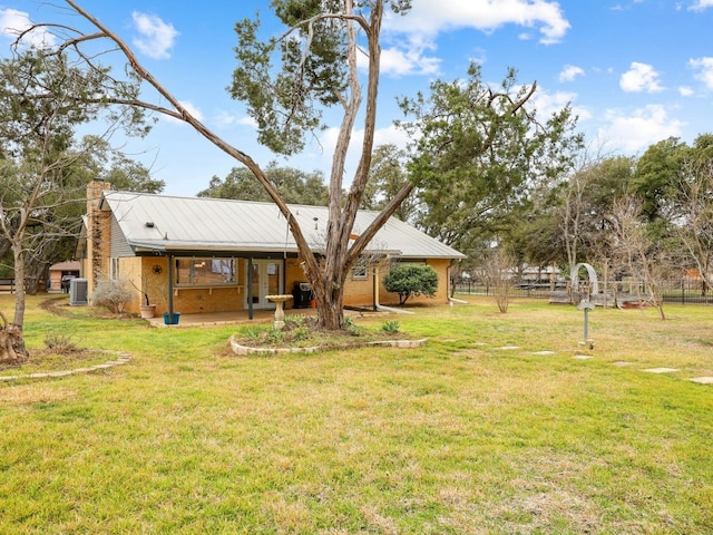 view of yard with fence and central AC unit