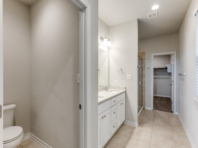 full bath with double vanity, visible vents, a sink, a shower stall, and tile patterned floors