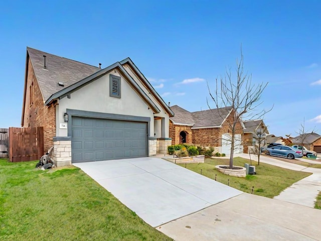 view of front facade featuring a garage, driveway, a front yard, and fence