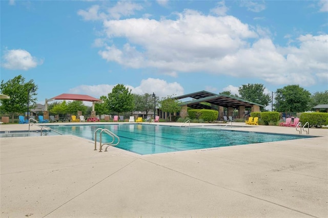 pool featuring a patio and fence