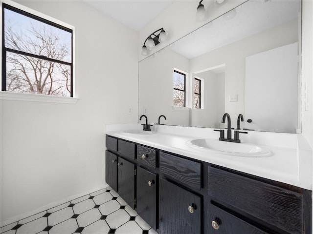 bathroom featuring double vanity, a sink, and tile patterned floors