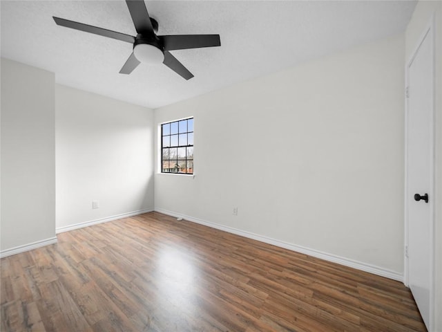 unfurnished room featuring a ceiling fan, a textured ceiling, baseboards, and wood finished floors