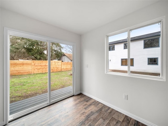 interior space with baseboards and wood finished floors