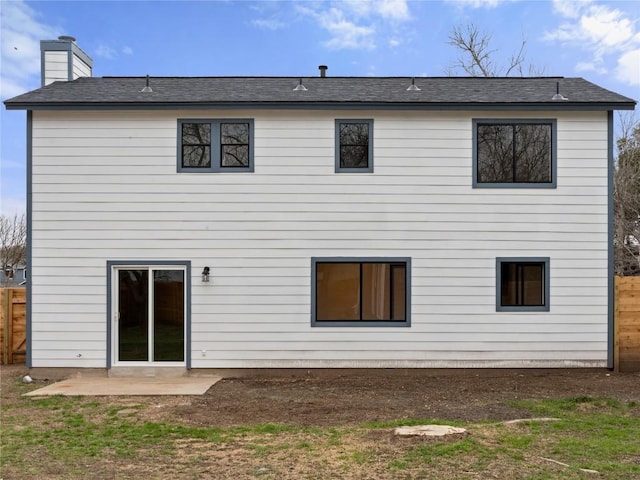 rear view of property with a patio area, a chimney, and fence