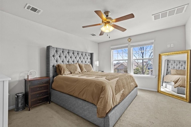 carpeted bedroom with visible vents, ceiling fan, and baseboards