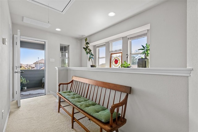 hall with attic access, visible vents, baseboards, carpet floors, and recessed lighting