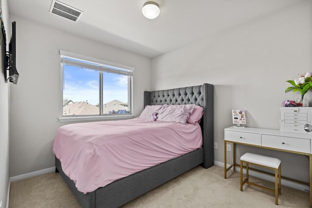 bedroom featuring baseboards, visible vents, and light colored carpet