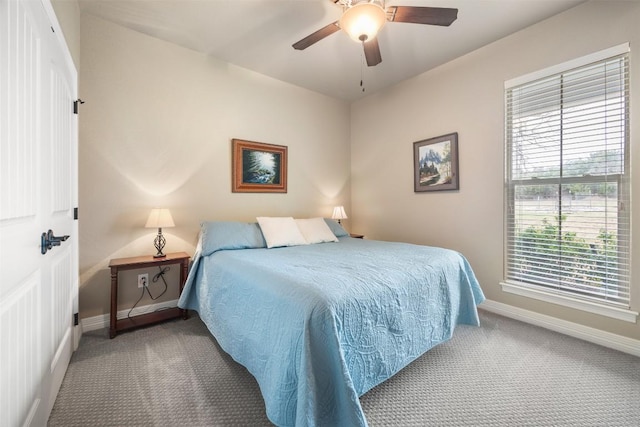 bedroom with carpet floors, baseboards, and a ceiling fan