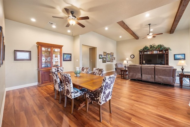 dining space with beam ceiling, visible vents, light wood-style floors, ceiling fan, and baseboards