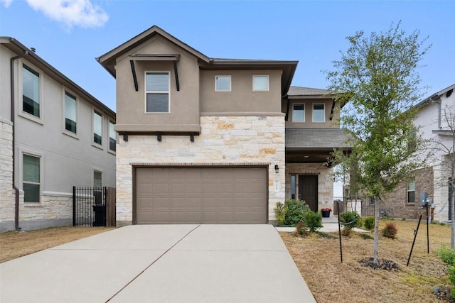 view of front of house with stone siding, concrete driveway, an attached garage, and stucco siding