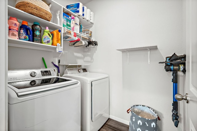 laundry room with washing machine and dryer, laundry area, baseboards, and wood finished floors