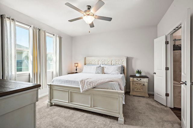 bedroom with baseboards, ceiling fan, and light colored carpet