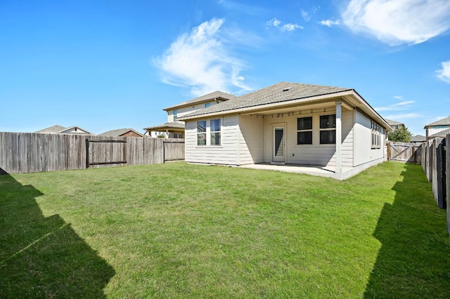 rear view of property featuring a patio area, a fenced backyard, and a yard