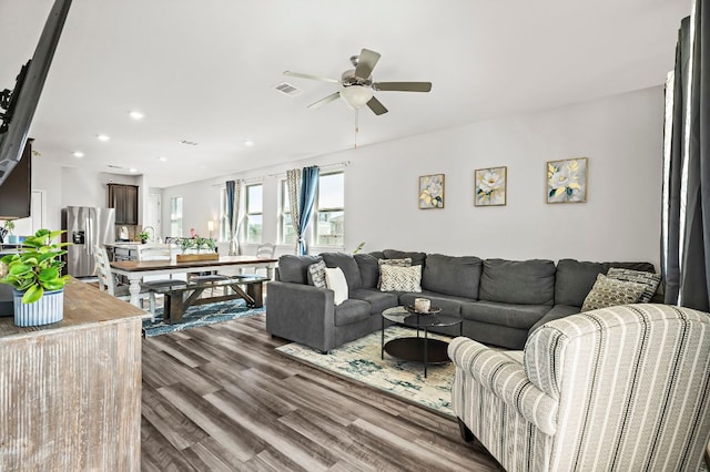 living room featuring a ceiling fan, recessed lighting, visible vents, and wood finished floors