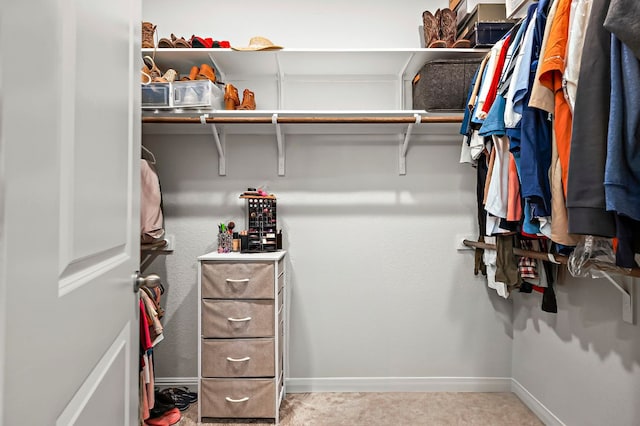 walk in closet with carpet flooring