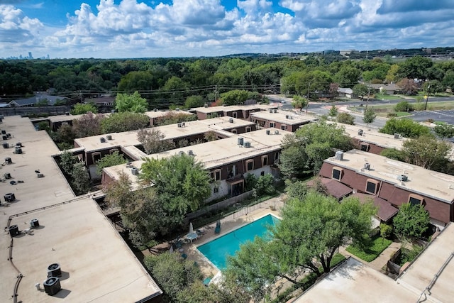 drone / aerial view with a wooded view