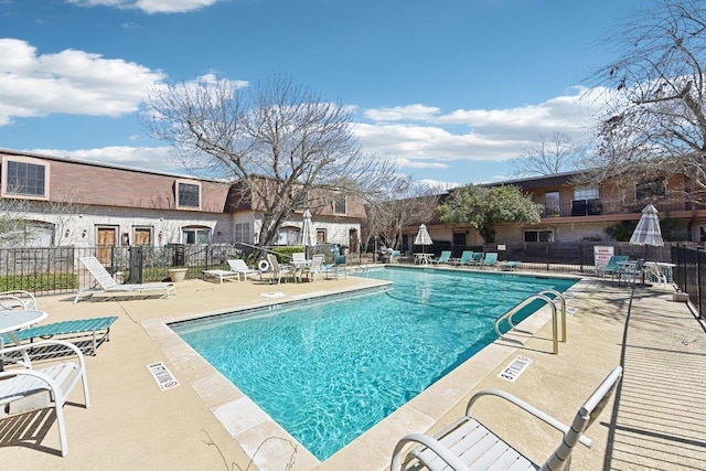 pool featuring a patio and fence