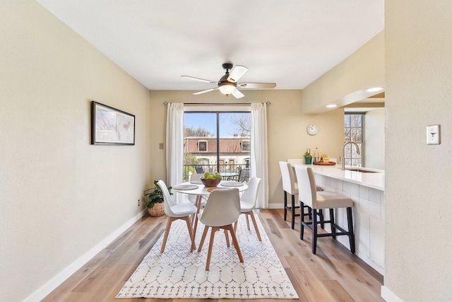 7801 Shoal Creek Blvd Unit 224, Austin, TX 78757 - dining space with ceiling fan, light wood finished floors, and baseboards