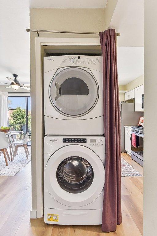7801 Shoal Creek Blvd Unit 224, Austin, TX 78757 - washroom with stacked washer and dryer, ceiling fan, and light wood-type flooring