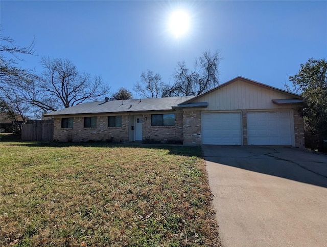 ranch-style home featuring driveway, an attached garage, fence, a front lawn, and brick siding