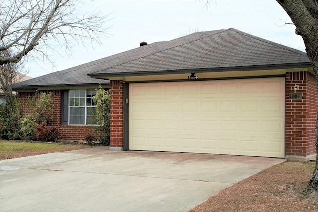 view of front of home featuring an attached garage, driveway, brick siding, and a shingled roof