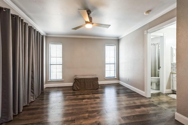 unfurnished room featuring a healthy amount of sunlight, baseboards, dark wood-type flooring, and crown molding