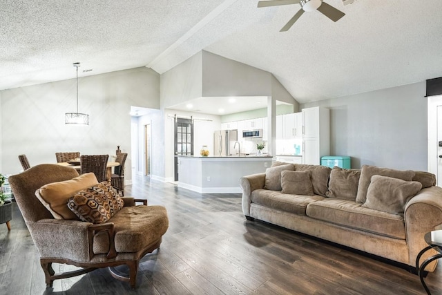 living room with baseboards, ceiling fan, dark wood-type flooring, vaulted ceiling, and a textured ceiling