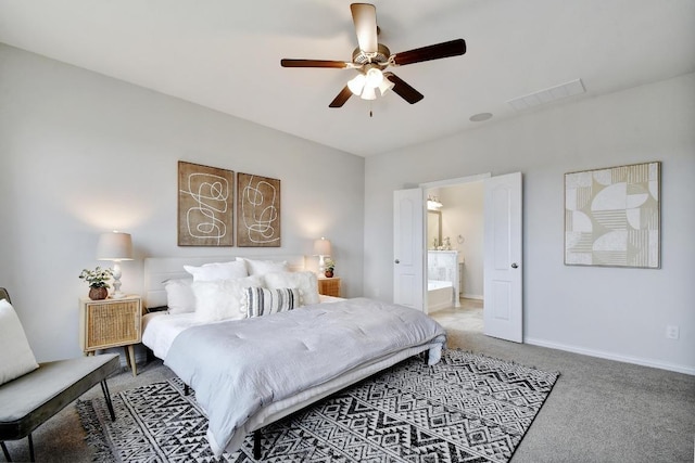 858 Cherrystone Loop, Buda, TX 78610 - carpeted bedroom featuring visible vents, ensuite bathroom, baseboards, and ceiling fan