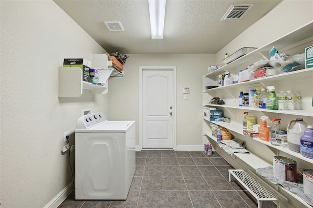 clothes washing area featuring a textured ceiling, laundry area, washer / clothes dryer, and visible vents