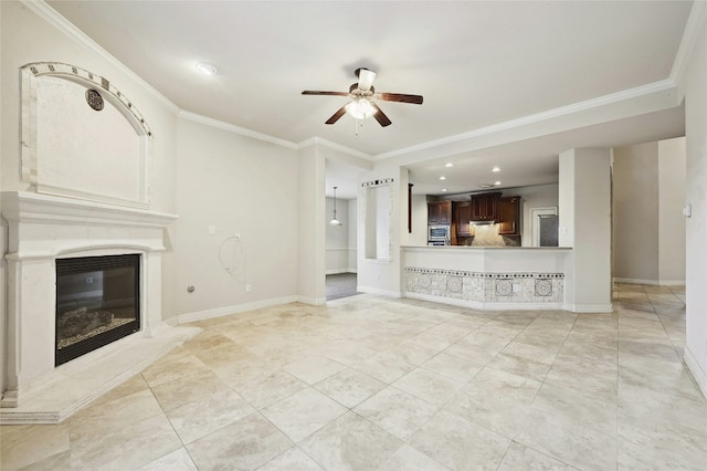 unfurnished living room featuring crown molding, a fireplace, baseboards, and a ceiling fan