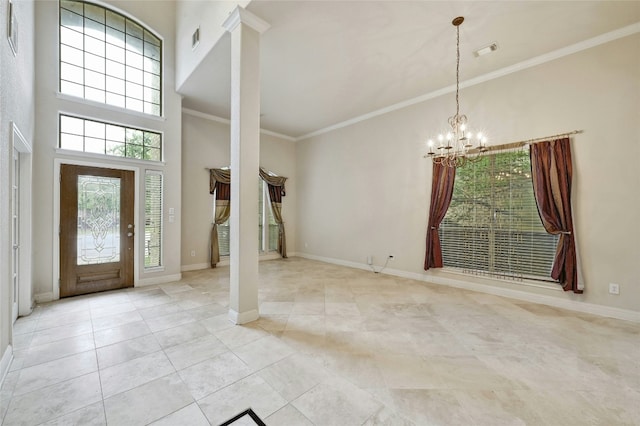 foyer featuring baseboards, visible vents, a high ceiling, crown molding, and a notable chandelier