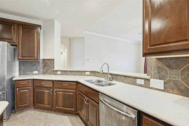 2989 Agave Loop, Round Rock, TX 78681 - kitchen with stainless steel appliances, a sink, light countertops, tasteful backsplash, and crown molding
