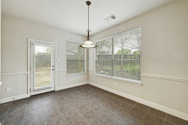 unfurnished dining area featuring visible vents and baseboards