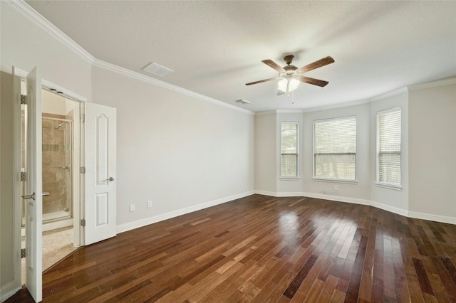 unfurnished room featuring baseboards, crown molding, visible vents, and dark wood-type flooring