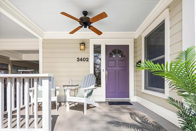 property entrance with a ceiling fan and covered porch