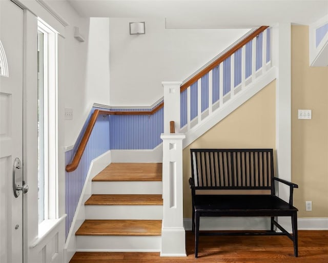 staircase with wood finished floors and baseboards