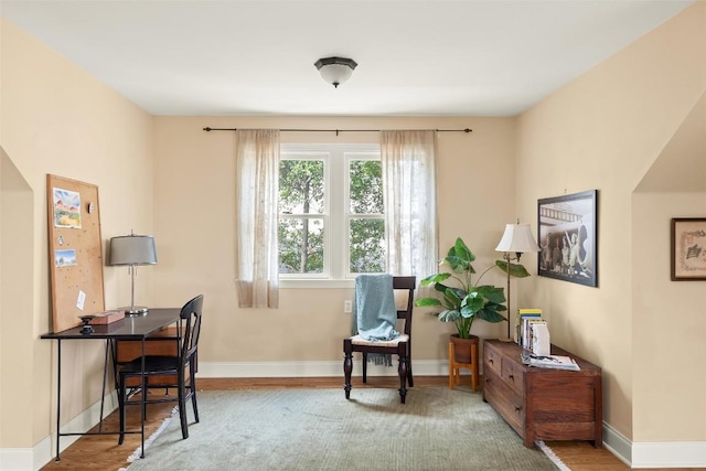 office space featuring baseboards and wood finished floors