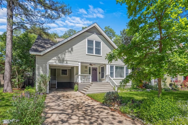 bungalow with a porch, ceiling fan, and concrete driveway