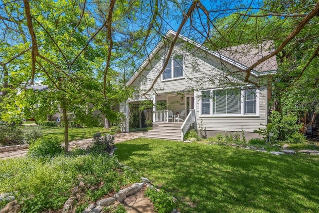 view of front of house with a porch and a front yard