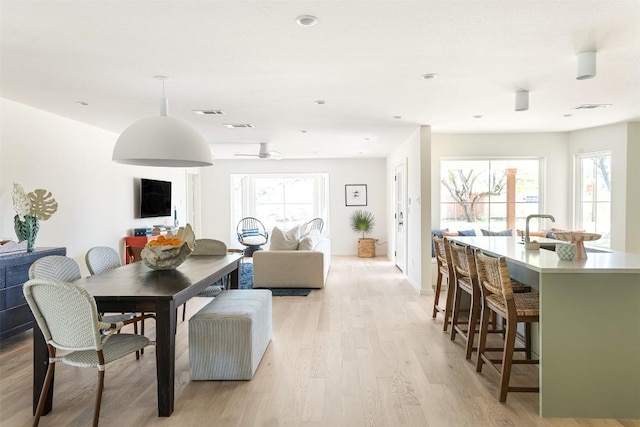 dining space with light wood-type flooring, visible vents, and recessed lighting