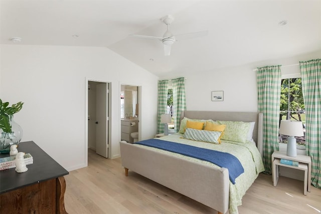 bedroom featuring ensuite bathroom, vaulted ceiling, ceiling fan, light wood-type flooring, and baseboards