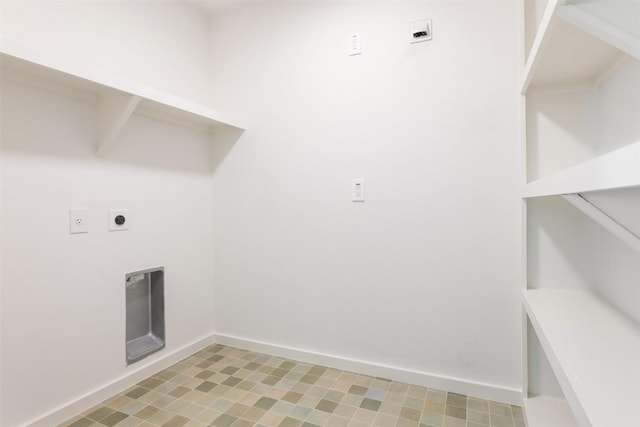 clothes washing area with laundry area, electric dryer hookup, and baseboards